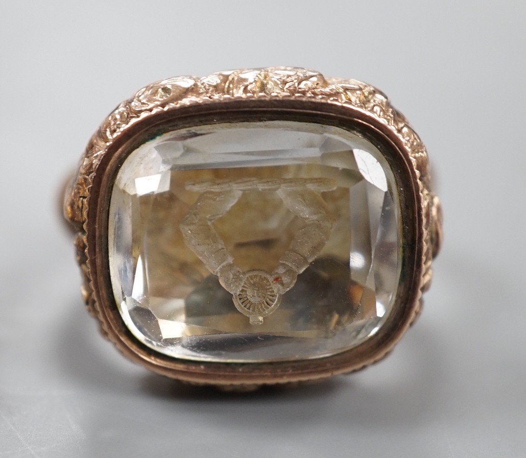 A late 19th/early 20th century yellow metal overlaid and foil backed rock crystal set fob seal with inset compass, 37mm and two other later hardstone set fob seals.